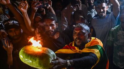 Sri Lankan demonstrators take part in a celebration in Colombo to mark the 100th day of protests. AFP