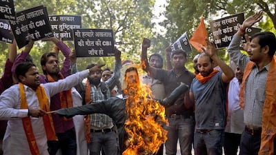 Right-wing Hindu activists burn an effigy of the Uttar Pradesh state chief minister, Akhilesh Yadav, yesterday in New Delhi demanding investigation by a central government agency into their claim that the farmworker lynched by a mob in a village near the capital had stored beef in his house. The inquiry by the regional government had ruled out that the farmer had a stock of beef. Saurabh Das / AP Photo