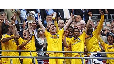 John Terry, second left, and Frank Lampard hold up the FA Cup after Chelsea's final victory.