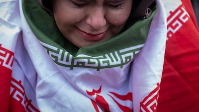 A young woman attends a funeral procession for those killed in the recent unrest in Iran, on January 14, 2026. AFP