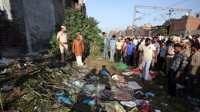 Police officers inspect at the site of a train accident in Amritsar, India, 20 October 2018. EPA
