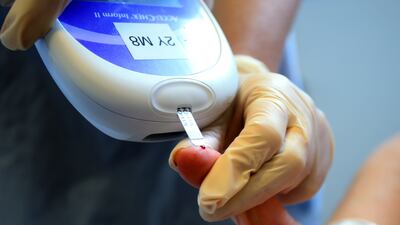 A nurse tests a patient for diabetes. Under-diagnosis is greatest in young adults, a global study found. PA