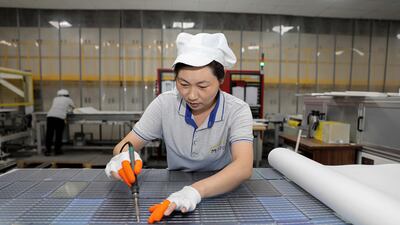 A worker produces solar photovoltaic modules used for solar panels in Huaian city, in eastern China's Jiangsu province. AFP