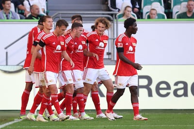 Union Berlin players celebrate scoring against Wolfsburg. AFP