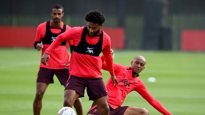 Fabinho and Joe Gomez fight for the ball during training.