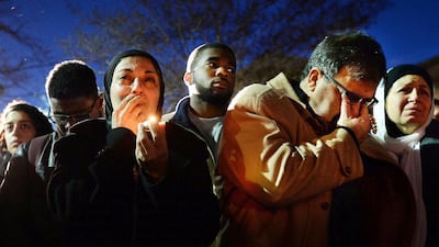 Namee Barakat, right, wipes away tears as he and his wife, Layla, watch photos projected onto a screen during a vigil for their son, daughter-in-law and her sister on February 11, 2015 in Chapel Hill, North Carolina. Chuck Liddy, The News & Observer/AP Photo