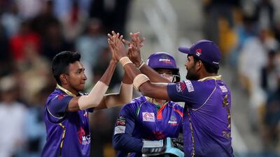 Bangla Tigers spinner Kevin Koththigoda, left, celebrates after taking the wicket of Qalanaders opener Dawin Malan. Chris Whiteoak / The National