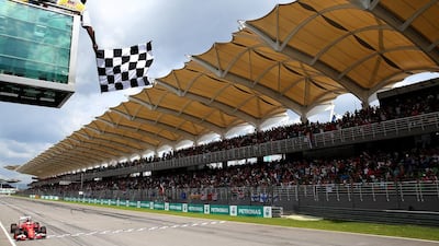 Vettel crosses the finish line and takes the Malaysian Grand Prix checkered flag. Mark Thompson / Getty Images