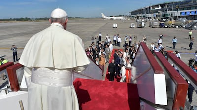 Pope Francis waves goodbye and boards his plane for Dhaka, Bangladesh, from Yangon's International Airport, Myanmar. Osservatore Romano / Handout via Reuters