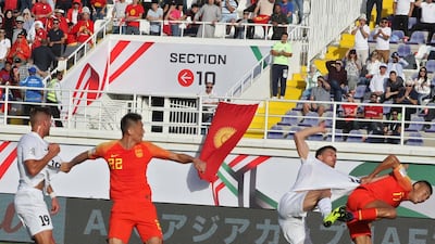 China's midfielder Zhang Chengdong fights for the ball with Kyrgyzstan's forward Mirlan Murzaev. AFP