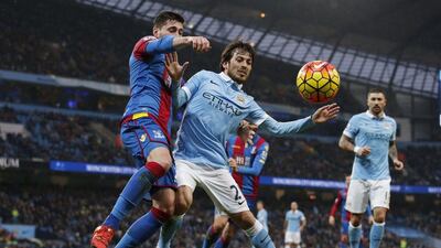 Manchester City’s David Silva vies for the ball with Crystal Palace’s Joel Ward on Saturday during their Premier League contest. Phil Noble / Reuters