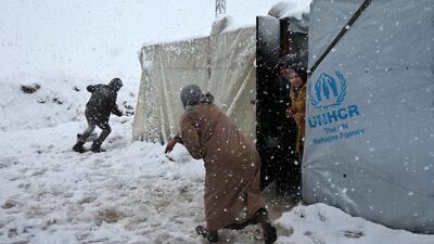 Syrians throw snow at each other. Hussein Malla / AP Photo
