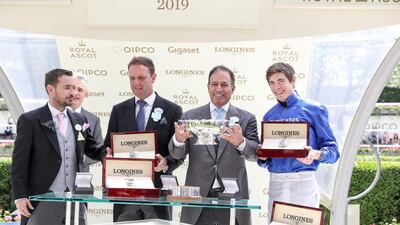 Jockey James Doyle (right), trainer Charlie Appleby (second left) and winning connections are presented with trophies by Martin Compston (left) after Pinatubo wins the Chesham Stakes during day five of Royal Ascot at Ascot Racecourse.