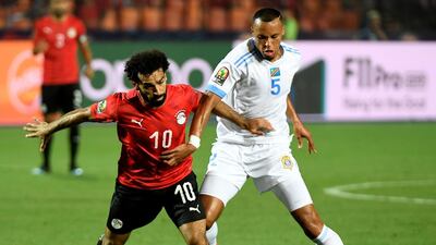 Egypt forward Mohamed Salah, left, fights for the ball with DR Congo's Marcel Tisserand. AFP