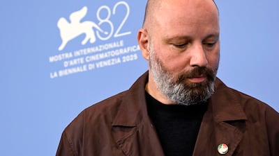 Director Yorgos Lanthimos wears a pin of the Palestine flag at a photocall for Bugonia. EPA