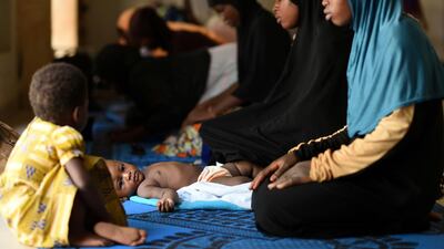 A girl lies down as women pray at a mosque in Ouagadougou, Burkina Faso. Reuters