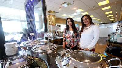 Sisters Deepa, left, and Maya John Marjoran have their hands full ushering in new technology, processes and a brand makeover at the Rainbow Steakhouse. Satish Kumar / The National