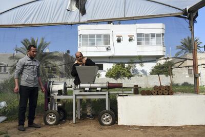 Mohammad El Gha, 31, and Yasser El Ghawaji, 47, process olive peel in Khan Yunis, southern Gaza. Rosie Scammell for The National