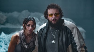 Among all the superheroes, Sarah Shahi and Mo Amer play two regular people.