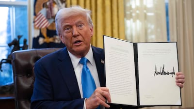 US President Donald Trump shows an executive order withdrawing his country from a number of UN agencies. AFP