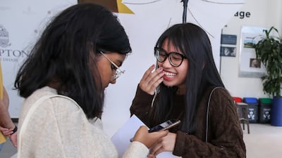 Pupils at Repton School in Abu Dhabi congratulate each other after they receive their A-level grades.