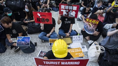 Demonstrators hold placards in the arrival hall. Bloomberg