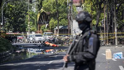 An Indonesian anti-terror policeman stands guard at the blast site following a suicide bomb outside a church in Surabay, East Java, Indonesia. Juni Kriswanto / AFP