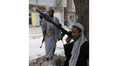 Followers of the Yemeni opposition man a checkpoint on a street leading to their stronghold in the southern city of Taiz yesterday.