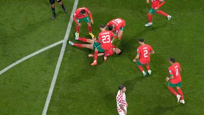 Achraf Dari, on the ground, celebrates after scoring. AP
