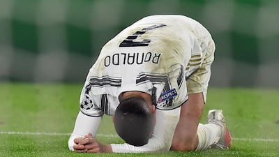 Cristiano Ronaldo slumps to the ground at the end of the match. EPA