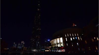 The Burj Khalifa skyscraper lit up and with the lights turned off during the earth hour environmental campaign in Dubai on March 24, 2018. Giuseppe Cacace / AFP