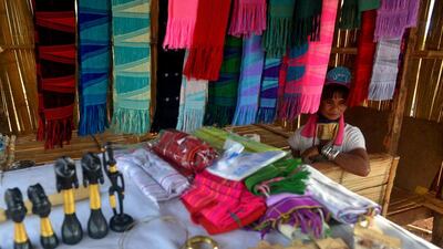 Mu Htwe sells handicrafts. Several Kayan tribeswoman have returned to their remote native Panpet area in Kayah state, Myanmar, with an entrepreneurial plan to reverse the flow of departures.