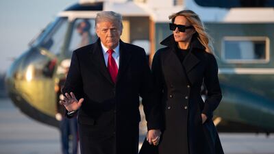 US President Donald Trump and First Lady Melania Trump walk to board Air Force One prior to departure from Joint Base Andrews in Maryland, December 23, 2020. AFP