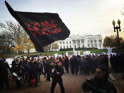 A Shia Muslim waves a flag in protest against ISIS and the use of terrorism in the name of Islam during a religious procession of US Shia Muslims outside the White House in Washington on December 6, 2015. AFP