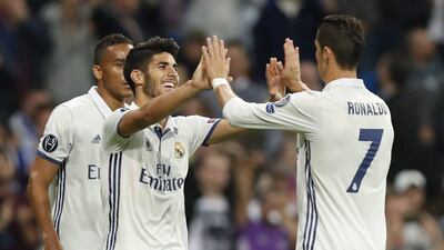 Real Madrid’s Marco Asensio, left, celebrates scoring the third goal. Javier Lizon / EPA