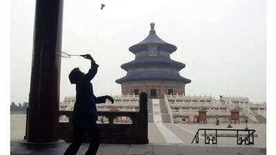 A woman plays badminton in the park at the Temple of Heaven in Beijing.