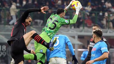 Napoli goalkeeper David Ospina takes a high catch under a challenge from AC Milan striker Zlatan Ibrahimovic. EPA