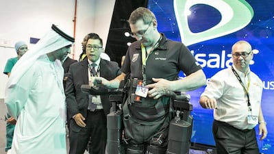 Kiwi Lee Warn demonstrates the Rex walker, a robotic exoskeleton, at Gitex Technology Week in Dubai. Amana Healthcare wants to bring the device to the UAE to help patients. Reem Mohammed / The National