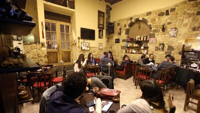 Syrians take advantage of a truce negotiated by the world powers to gather at a coffee shop in Damascus. Louai Beshara / AFP