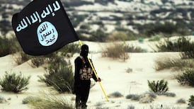 A fighter from ISIS under its black banner. The group claims it has renewed its campaign of violence in Syria. Getty Images
