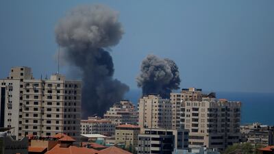 Smoke rises following Israeli airstrikes on a building in Gaza City on May 13. AP