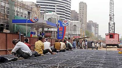 Indian labourers work at a construction site in New Delhi in June. Parts of the Indian capital remain untidy construction sites as renovations and infrastructure investment continue ahead of the forthcoming Commonwealth Games.