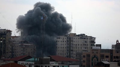 Smoke rises as Al Zafir tower collapses after it was targeted by Israeli warplanes in Gaza City on August 23. EPA