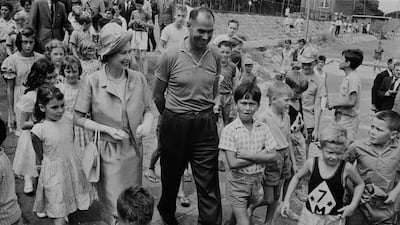 Queen Elizabeth is surrounded by school children at a children's playground in Sydney during a Commonwealth visit to Australia in 1963. Getty Images