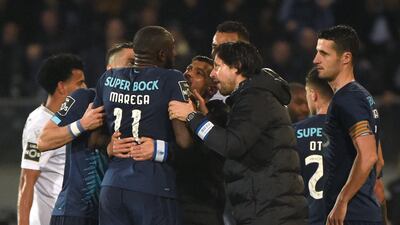 FC Porto's Malian forward Moussa Marega attempts to leave the pitch after hearing racists chants as his coach Sergio Conceicao tries to stop him. AFP