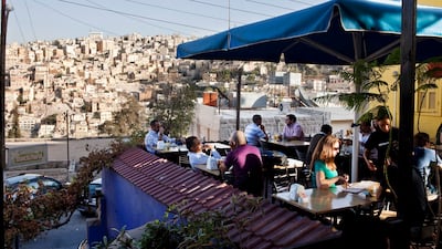 People watch the sunset at Books@Cafe in the trendy Jabal Amman district. Photo: Getty Images