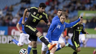 Spain's forward Diego Costa, left, never looked comfortable as the focal point of the Spain attack as the defending champions were the first team to exit the tournament. AFP PHOTO / DANI POZO