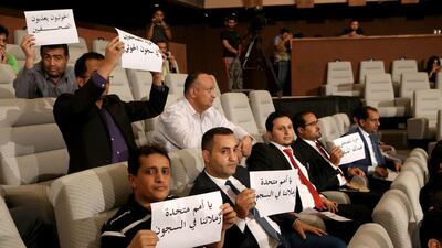Yemeni journalists hold placards in support of colleagues jailed in Houthi prisons during a press conference of the United Nations Special Envoy to Yemen on May 5, 2016 at the information ministry in Kuwait City. Yasser Al Zayyat/AFP