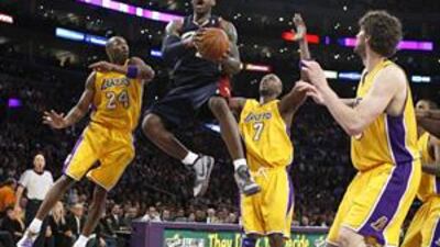The Cleveland Cavaliers forward LeBron James shoots while being guarded by the Golden State Warriors guard Kelenna Azubuike, centre, and Andris Biedrins right, during Friday's game.