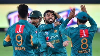 Shadab Khan celebrates the dismissal of Australia batsman Chris Lynn, whose wicket was one of three the Pakistan leg-spinner took on Sunday night. AFP